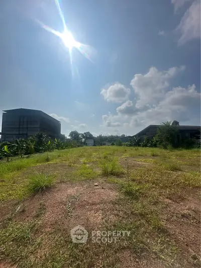 Expansive land plot with clear skies, perfect for development opportunities.