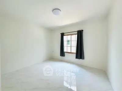Spacious empty room with large window and elegant curtains, perfect for customization.