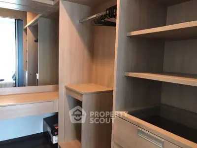 Spacious walk-in closet with wooden shelves and ample storage space.