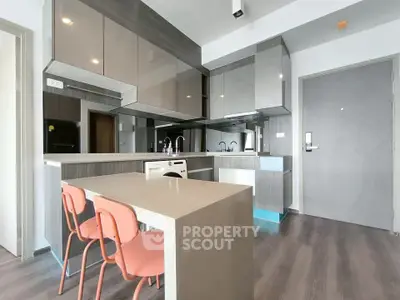 Modern kitchen with sleek cabinetry and compact dining area
