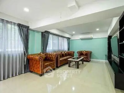 Spacious living room with elegant leather sofas and modern decor