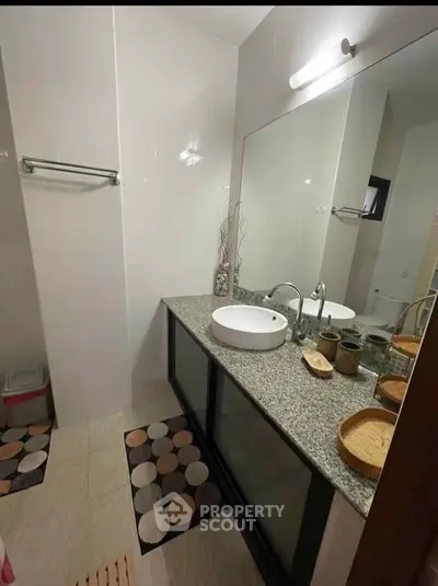 Modern bathroom with granite countertop and stylish decor