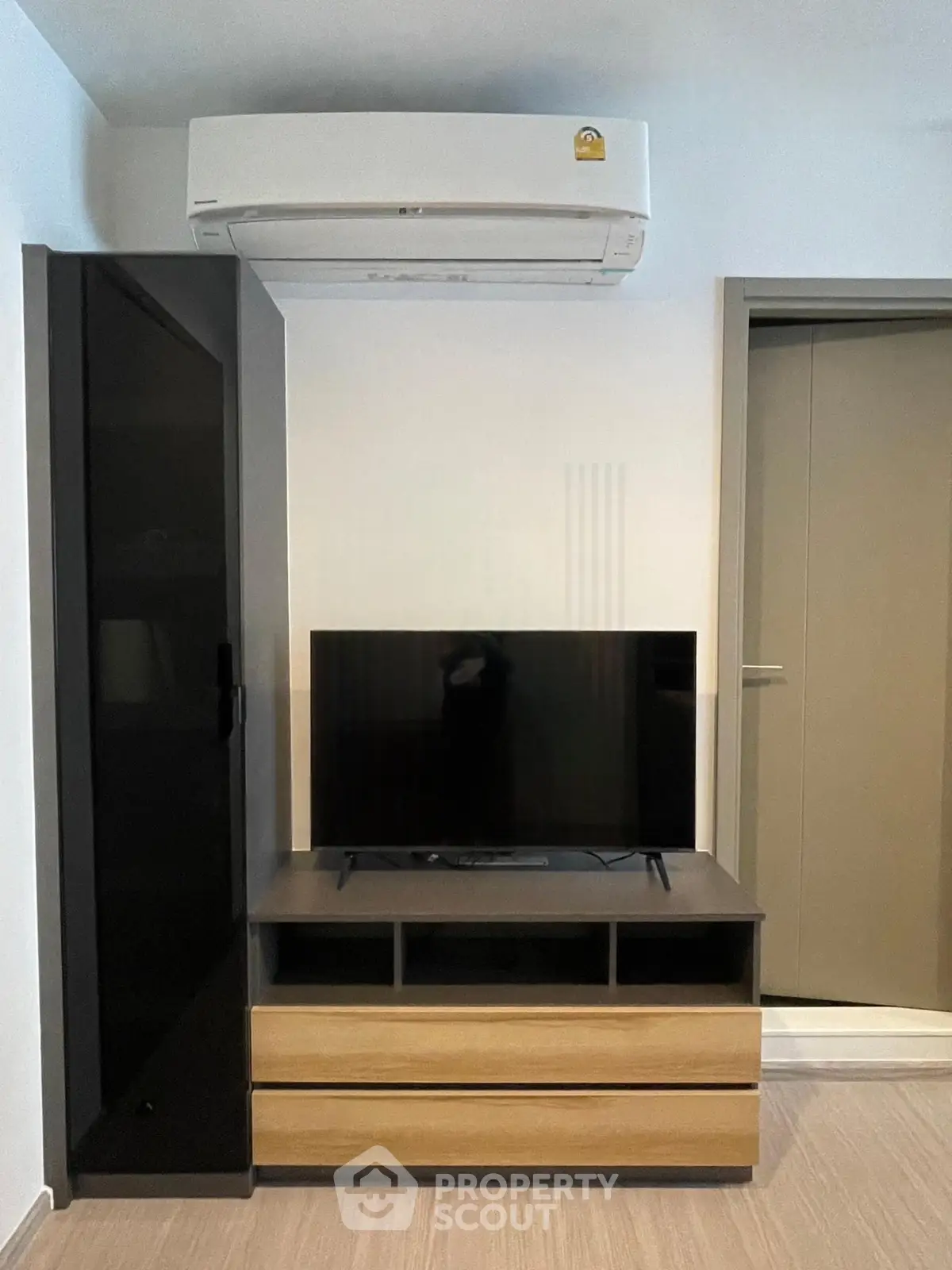 Modern living room with sleek TV stand and air conditioning unit