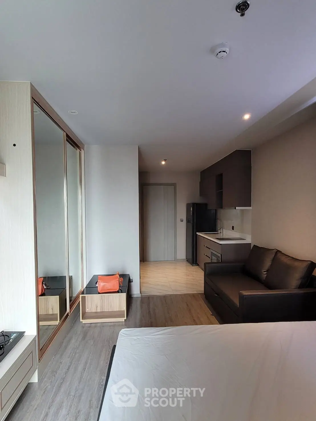 Modern studio apartment with sleek kitchen and cozy living area, perfect for urban living.