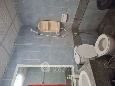 Modern bathroom with blue tiles and sleek fixtures