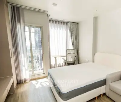 Bright modern bedroom with balcony access and stylish furnishings