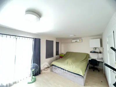 Spacious bedroom with modern decor and natural light