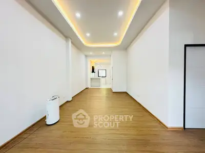 Spacious modern living room with elegant lighting and wooden flooring