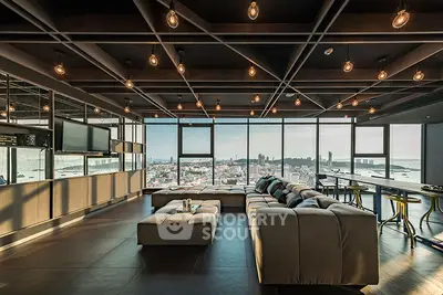 Luxurious living room with panoramic city and sea views, modern lighting, and spacious seating area.