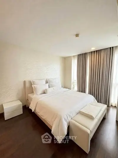 Elegant bedroom with modern decor and large windows for natural light