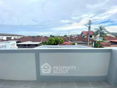 Charming balcony with scenic neighborhood view and clear skies
