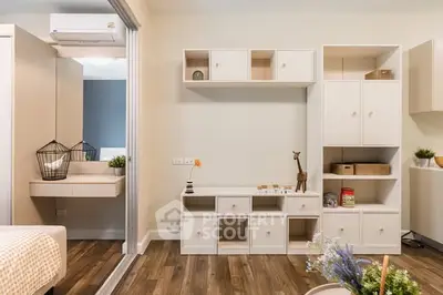 Modern living room with stylish white shelving and wooden flooring