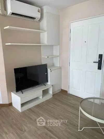 Modern living room with sleek TV stand and air conditioning unit