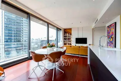 Luxurious modern living room with city view, open layout, and stylish furnishings.