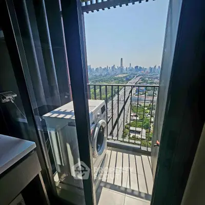 High-rise balcony with washing machine and stunning city skyline view.