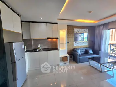 Modern open-layout kitchen and living room with sleek design and balcony view.