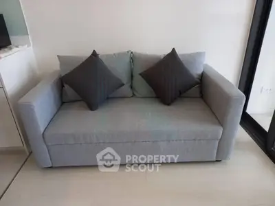 Modern gray sofa with cushions in a stylish living room setting