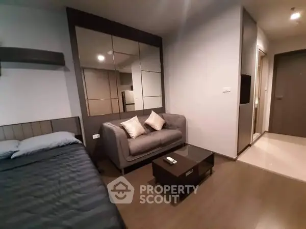 Modern studio apartment with cozy living area and stylish decor