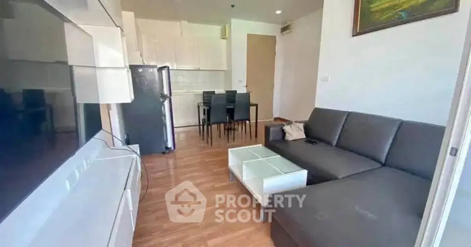 Modern living room with sleek furniture and open kitchen layout