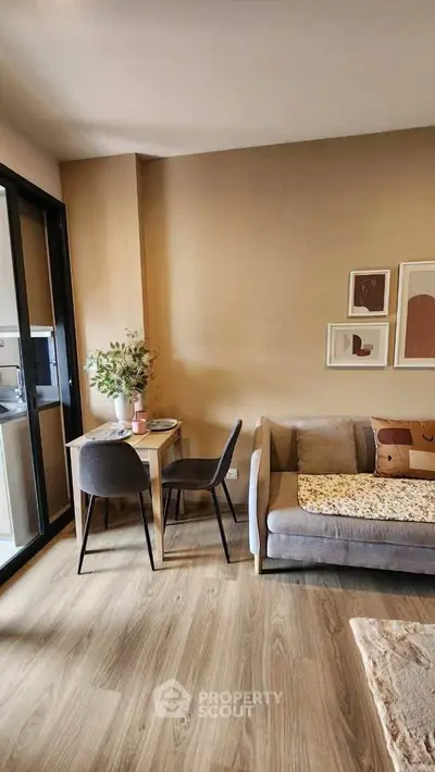 Charming living room with cozy seating and dining area, featuring elegant decor and natural light.