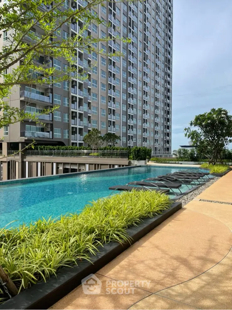 Luxurious high-rise building with stunning poolside view and lush greenery, perfect for modern urban living.