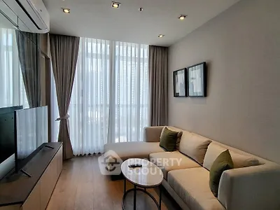 Modern living room with large windows and stylish furniture