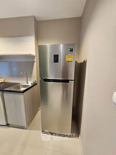 Modern kitchen with stainless steel fridge and sleek cabinetry