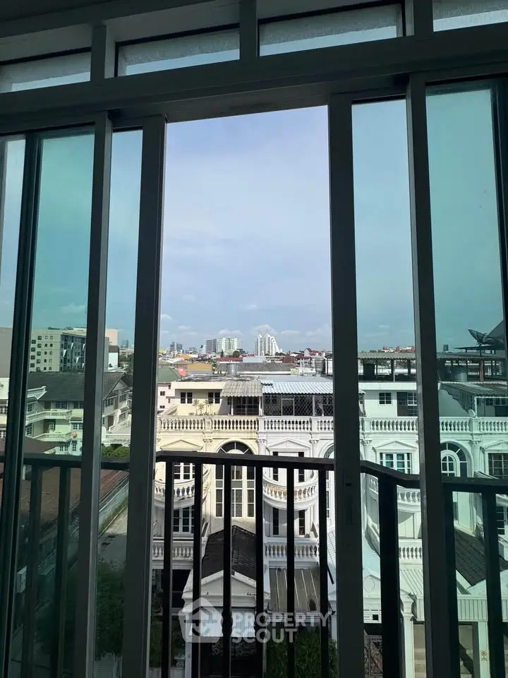 Stunning cityscape view from a modern apartment window, showcasing urban architecture and skyline.
