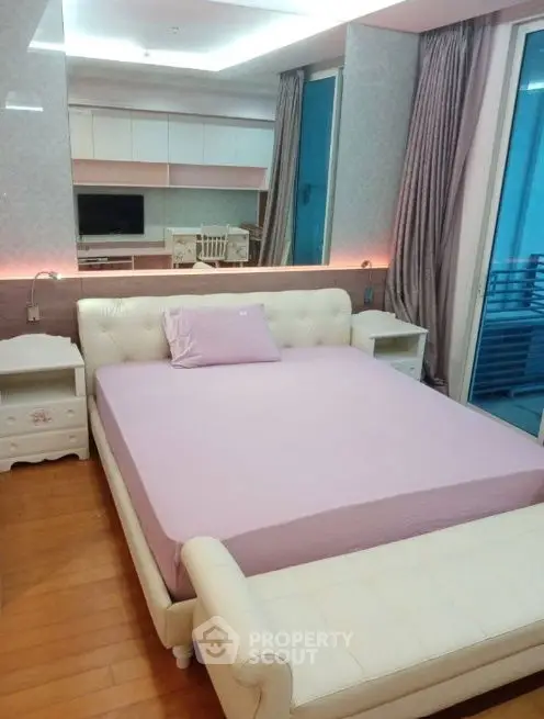 Luxurious bedroom with elegant decor and balcony access in modern apartment.