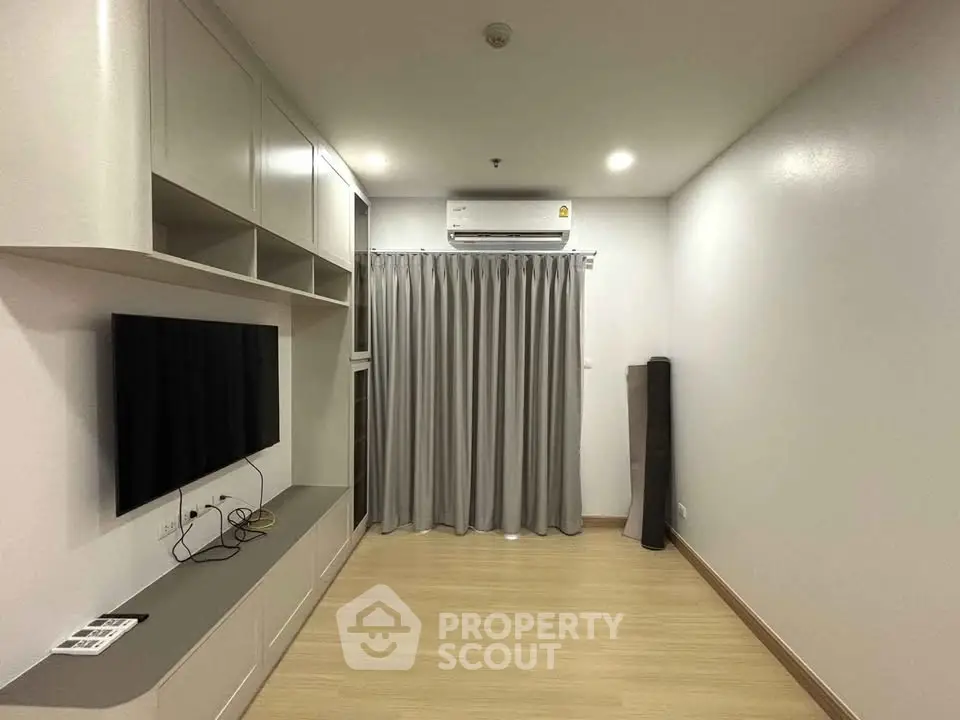 Modern living room with sleek built-in storage and air conditioning
