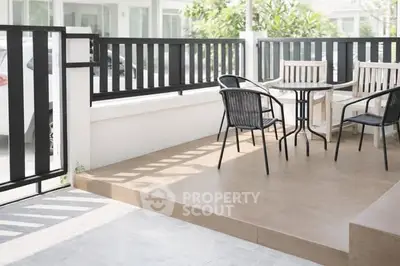 Charming patio with stylish outdoor seating in a modern home setting.