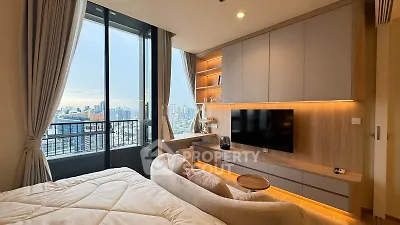 Luxurious bedroom with stunning city view and modern entertainment setup