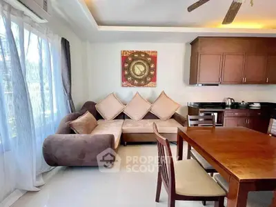 Charming living room with cozy sofa and elegant dining area, perfect for relaxation and entertaining.