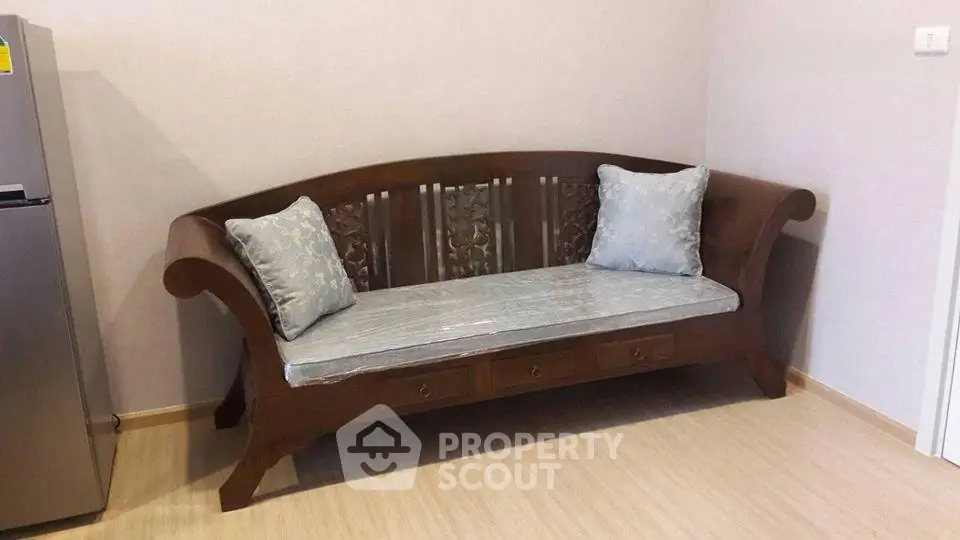Elegant wooden sofa with cushions in a cozy living room corner, perfect for relaxation.