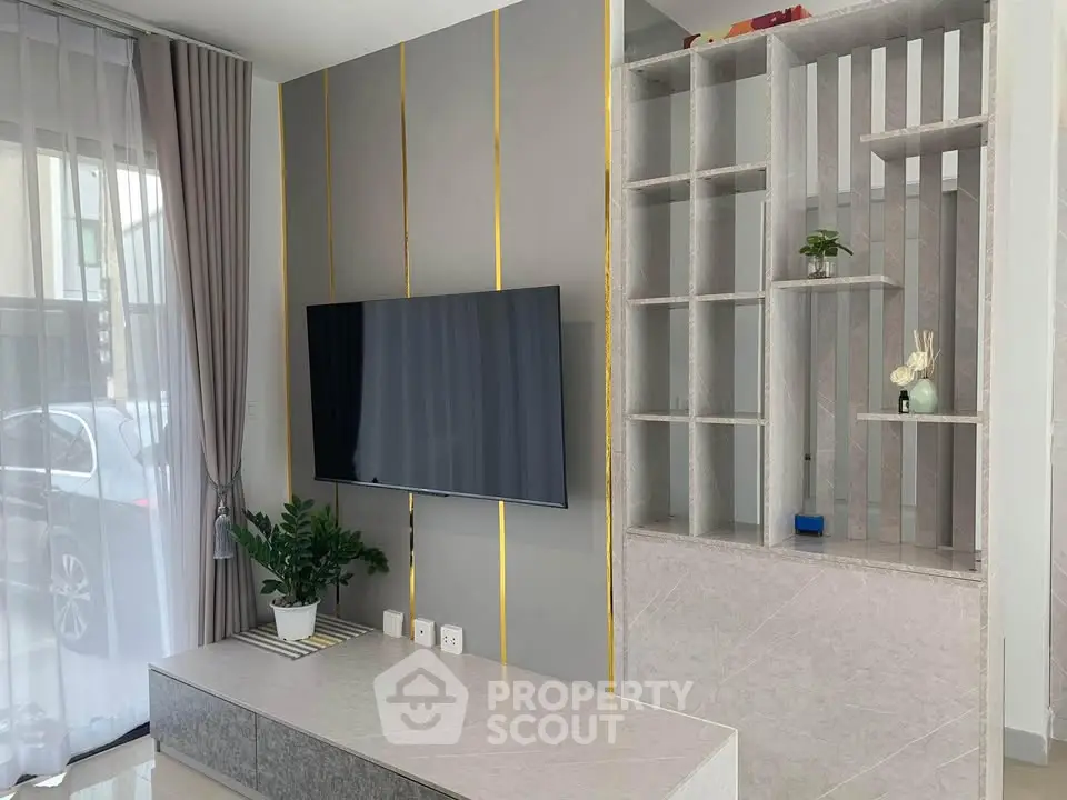 Modern living room with sleek TV setup and stylish shelving unit