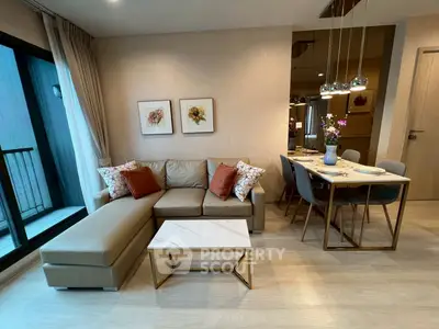 Modern living room with stylish decor and dining area in open layout apartment.