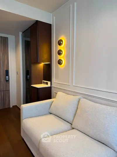 Modern living room with stylish lighting and cozy sofa in a contemporary apartment.