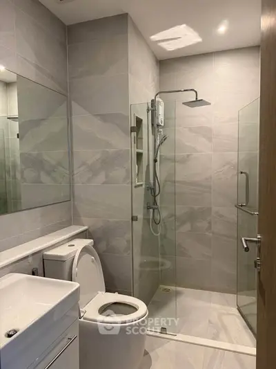 Modern bathroom with sleek glass shower and elegant tile design