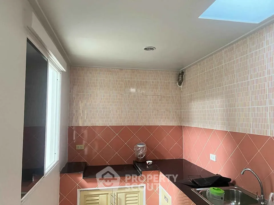 Charming kitchen with modern tiles and sleek countertops, perfect for culinary enthusiasts.