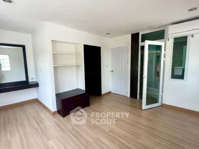 Spacious bedroom with modern design and ample natural light