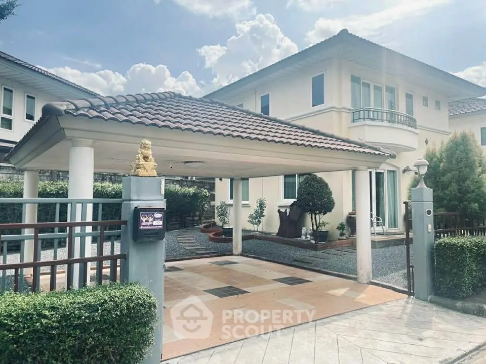 Elegant two-story house with tiled roof and spacious driveway in a serene neighborhood.