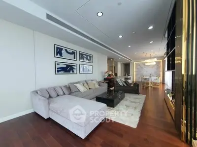 Luxurious modern living room with elegant decor and spacious layout, featuring plush seating and stylish artwork.