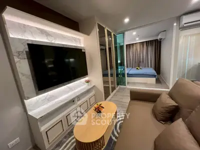 Modern living room with stylish decor and view into cozy bedroom