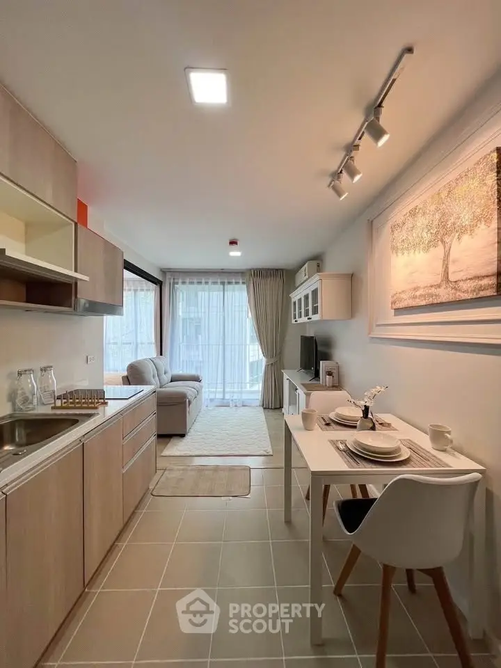 Modern open-plan kitchen and living room with stylish decor and natural light.