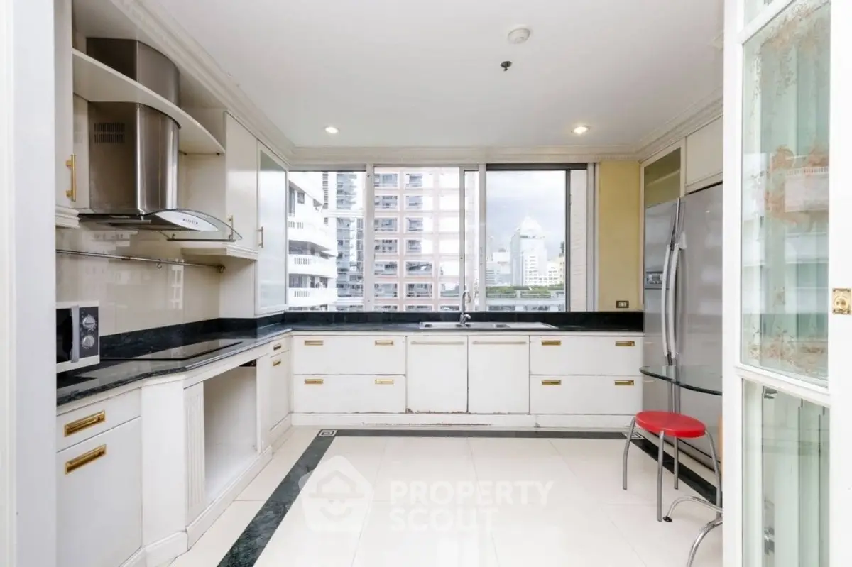 Spacious kitchen with city view, modern appliances, and sleek design