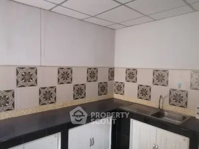 Modern kitchen with tiled backsplash and sleek countertops