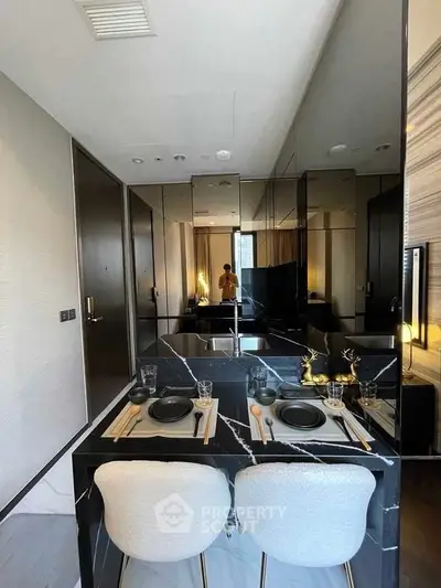 Luxurious modern kitchen with elegant black marble dining area and stylish decor.