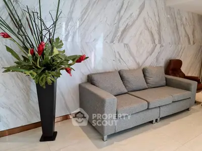 Elegant modern living room with stylish gray sofa and decorative plant