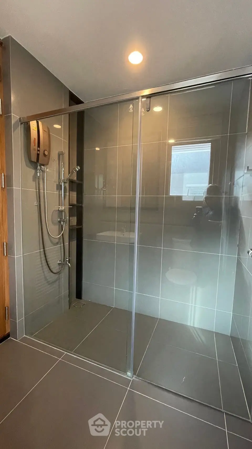 Modern bathroom with sleek glass shower enclosure and contemporary fixtures.