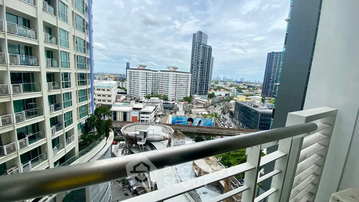 Stunning urban cityscape view from a high-rise balcony, showcasing modern architecture and vibrant skyline.